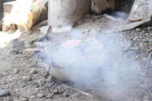 Chicken satay being grilled over coals photo