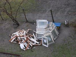 Construction debris from the dismantling of old windows in the courtyard of the house photo