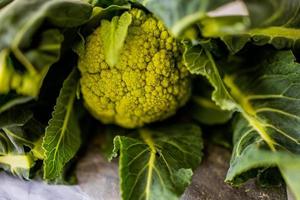 green organic green cauliflower on a kitchen countertop in closeup photo