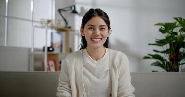 Portrait of A smiling Asian young woman looking at the camera with a big grin photo