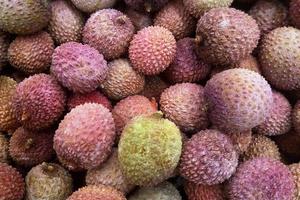 Stack of Lychees on a market stall photo