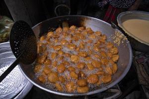 View of Traditional Bangladeshi street food Potato bora , Chop fried on the pan photo