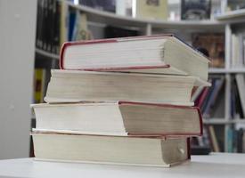 Old dirty books on the table. Books blurred background. photo