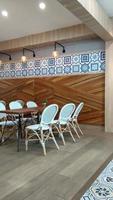 A restaurant with a blue and white tile wall and a wooden wall with a blue and white tile pattern. photo