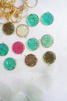 A collection of colorful glass beads are displayed on a white surface. photo