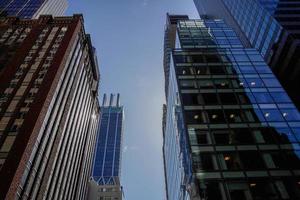 new york manhattan skyscrapers view from the street to the top of the building on sunny clear day photo