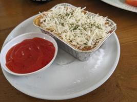 Cedar Cheese and mozzarella on the roasted beef lasagna with chili sauce. The photo is suitable to use for food background, poster and food content media.