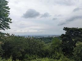 Landscape of hilltop with cloudy vibes when rain season. The photo is suitable to use for environment background, nature poster and nature content media.