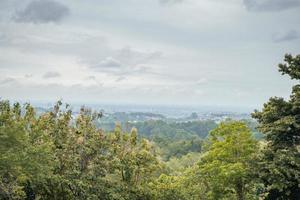 Landscape of hilltop with cloudy vibes when rain season. The photo is suitable to use for environment background, nature poster and nature content media.