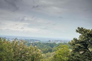 Landscape of hilltop with cloudy vibes when rain season. The photo is suitable to use for environment background, nature poster and nature content media.