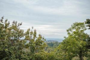 Landscape of hilltop with cloudy vibes when rain season. The photo is suitable to use for environment background, nature poster and nature content media.