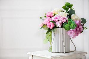 Beautiful peonies in a paper box on a white background. photo