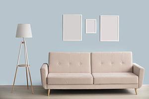 Minimalist interior. Sofa lamp picture frames on a blue wall background. photo