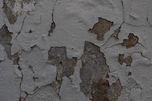 background of old colorful wall with cracked plaster in close-up photo