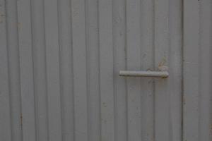 door handle on a background of a gray gate as a background photo