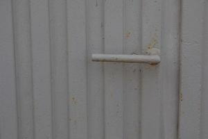 door handle on a background of a gray gate as a background photo