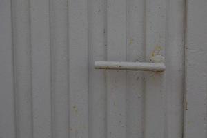 door handle on a background of a gray gate as a background photo