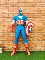 Captain America model beside the brick wall photo