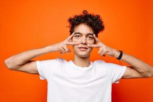 cute guy gesturing with hand emotions modern style orange background photo
