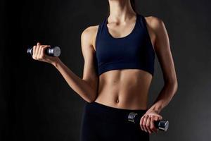 woman with dumbbells in hands fitness motivation workout slim figure photo