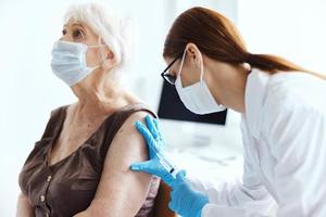 elderly woman with a doctor covid-19 passport immunity protection photo
