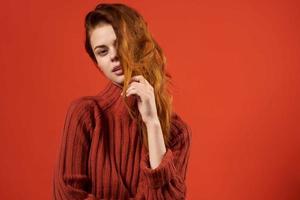 woman in red sweater lifestyle glamor cosmetics red background photo