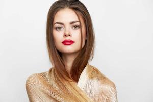 A portrait of a woman with a scarf with cosmetics on the face isolated photo