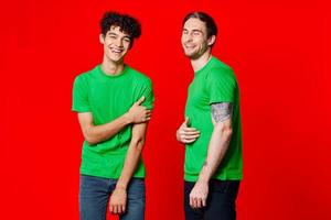 Cheerful friends in green t-shirts communication emotions isolated background photo