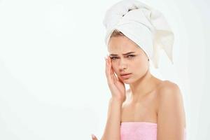 woman with bare shoulders with a towel on her head clean skin photo