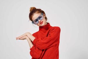 portrait of a woman fashionable blue glasses posing light background photo