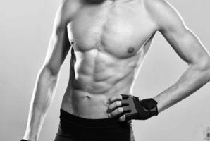 male athlete in sports gloves pumped up press workout fitness photo