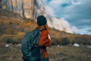 travel tourism woman with backpack high mountains sky landscape photo