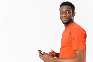 handsome african man with mobile phone on light background photo