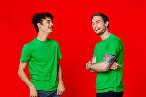 Cheerful friends are standing next to communication fun red background photo