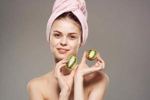pretty woman naked shoulders spa treatments clear kiwi skin in hands photo