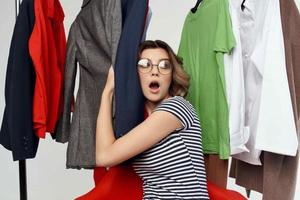 pretty woman with glasses trying on clothes shop shopaholic emotions photo