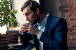 man in a suit with a cup of coffee in his hands breakfast lifestyle leisure photo