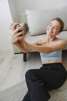 Happy smile woman holding an old camera and taking pictures of herself as a weekend photographer in home clothes with a short haircut hair without filters on a white background, free copy space photo