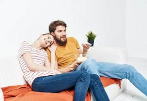 Pretty woman and man on sofa orange plaid and flower in pot love family photo