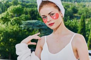 Woman in a bathrobe in a white robe the balcony overlooks the mountains unaltered photo