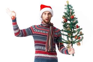 Cheerful man in New Year's clothes decoration christmas studio posing photo