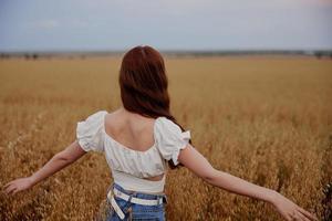 red-haired woman in the field countryside freedom summer photo