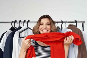 woman trying on a red shirt isolated background photo