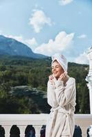pretty woman posing against the backdrop of mountains on the balcony architecture Relaxation concept photo