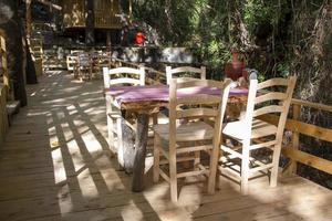 Wooden table and chairs in a cafe in the countryside photo