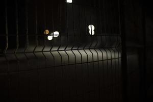 Fence at night. Mesh for protection. Grille on black background. photo