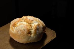 Freshly baked bread on rustic wooden table photo