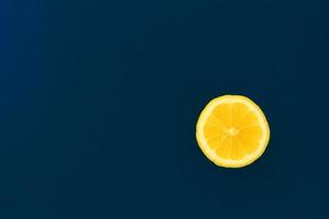 Yellow lemon on a blue background with copyspace. Design, Fine Art, Minimalism photo