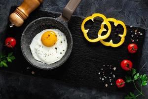 Complete Fry Egg Breakfast with Vegetables and spices. Top view. Copy space. photo