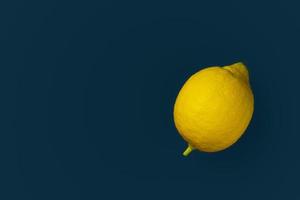 Yellow lemon on a blue background with copyspace. Design, Fine Art, Minimalism photo